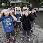 Schoolchildren watch the solar eclipse in Fujisawa, near Tokyo (AP Photo/Shizuo Kambayashi)