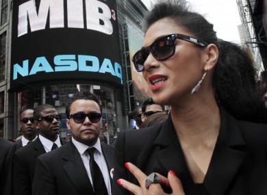 Singer Nicole Scherzinger - who appears in the latest Men in Black film - poses in front of the Nasdaq MarketSite in New York to promote the film.