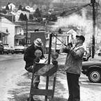 In this April 1981 file photo, US Bureau of Mines workers drop a thermometer through a hole on Main Street in Centralia to measure the heat from the shaft mine blaze that burned under the town. Compare the number of buildings in this picture to the previous photographs in this slideshow... (Image: AP Photo/Paul Vathis, File)