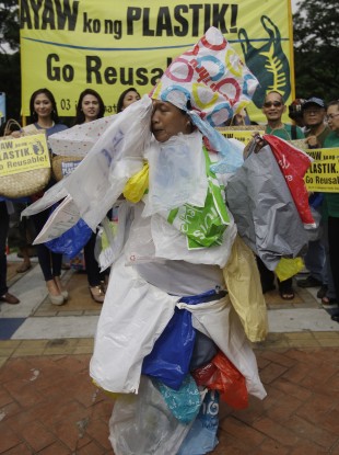 A plastic bag protester wears plastic bags for the International Plastic Bag-Free Day in Manila
