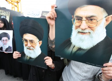This file photo shows female Iranian students holding posters of supreme leader Ayatollah Ali Khamenei.