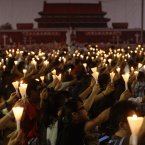People hold up lit candles during a candlelight vigil at Hong Kong's Victoria Park to mark the 23rd anniversary of the Chinese military crackdown on the pro-democracy movement in Beijing. (AP Photo/Kin Cheung)