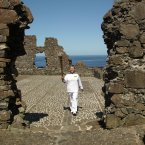Jean Jones holds the Olympic Flame in front of Dunluce Castle.