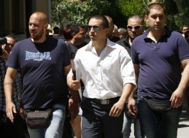 Ilias Kasidiaris, centre, pictured with other Golden Dawn members at the prosecutor's office in Athens.