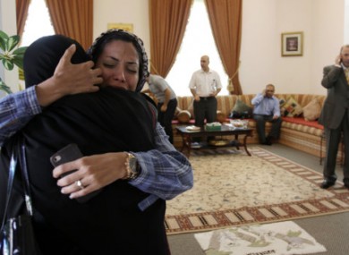 Dr Fatima Haji (second from left) hugs another woman after hearing of the judge's verdict today.