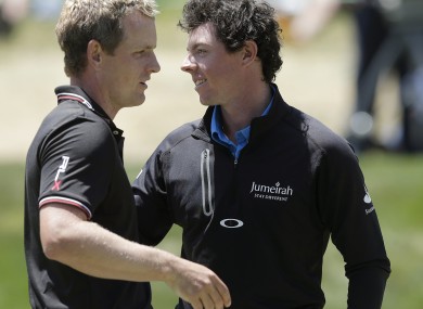 Luke Donald and defending champion Rory McIlroy embrace after their second round efforts.