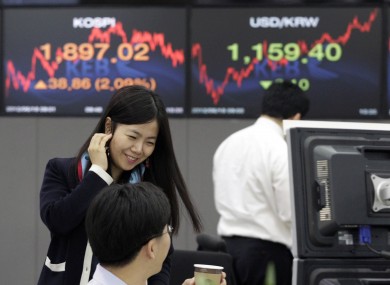 A currency trader reacts during a morning session at the foreign exchange dealing room of the Korea Exchange Bank headquarters in Seoul