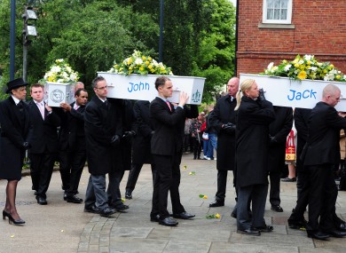 Coffins being carried into St Mary's Church in Derby this morning