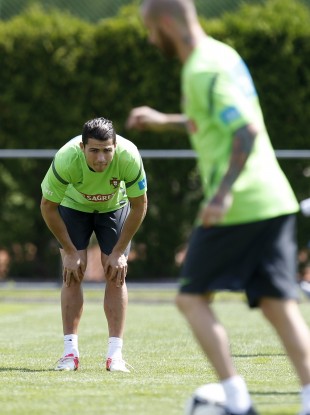 Portugal's Cristiano Ronaldo watches teammate Raul Meireles during squad training.