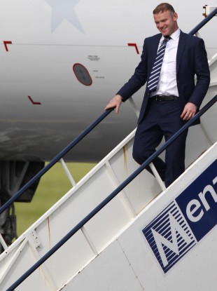 Wayne Rooney arrives at Manchester airport this morning.
