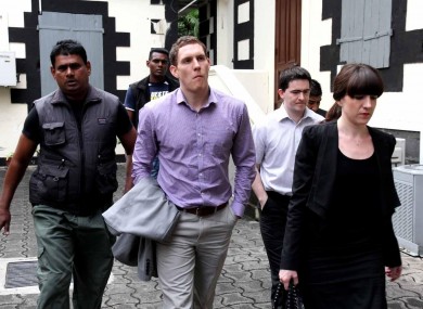 John McAreavey with his sister Claire (right) and Mark Harte (second right), brother of Michaela, pictured at the court in Mauritius today