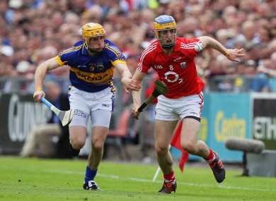 Cork's Darren Sweetman and Shane McGrath of Tipperary battle for possession.