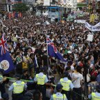 A line of trams are blocked by tens of thousands of Hong Kong residents (AP Photo/Vincent Yu)