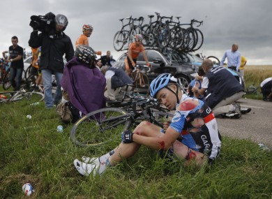The injured Thomas Danielson sits in the grass following yesterday's sixth stage.