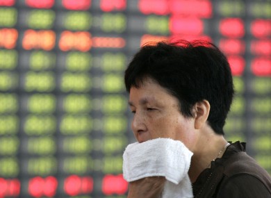 An investor looks at a stock price monitor in Shanghai, China last week.