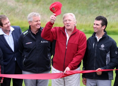 Donald Trump cuts the ribbon watched by son Donald Trump Jnr (right) and Colin Montgomerie with George O'Grady, Chief Executive of The European Tour (far left).