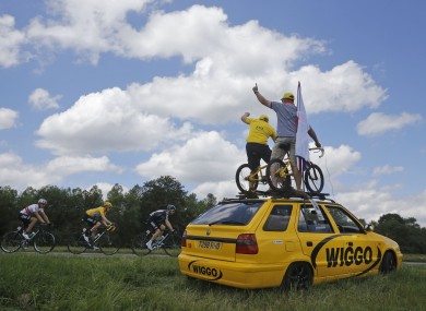 Supporters of Bradley Wiggins cheer on the yellow jersey holder yesterday.