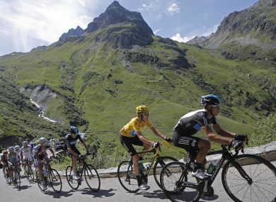 Bradley Wiggins of Britain, wearing the overall leader's yellow jersey, climbs Croix de Fer pass.