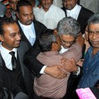 Sandip Mooneea (centre front) embraces Rama Valayden after he was acquitted