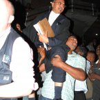 Sanjeev Teeluckdharry is held aloft by supporters of the Treebhoowoon family outside the Supreme Court