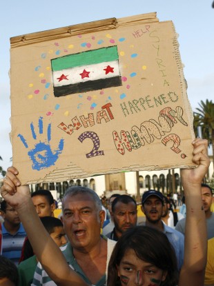 A Syrian expatriate family shouts as a girl holds a banner during a protest in solidarity with the Syrian people, in Casablanca, Morocco yesterday