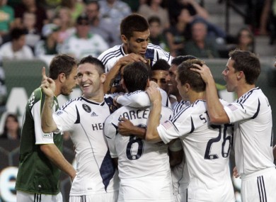 The Galaxy players mob Beckham after his second goal.