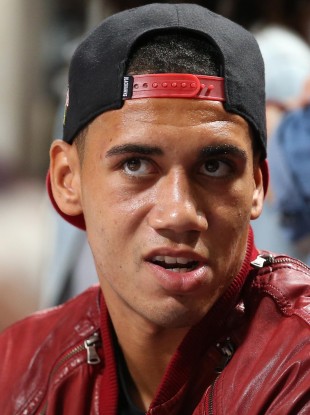 Manchester United's Chris Smalling watches the basketball action during an Olympic warm-up between USA and Team GB.