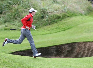 On the run: Rory McIlroy sprints across the green during day two.