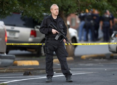 A SWAT team officer stands watch near an apartment house where the suspect in a shooting at a movie theatre lived in Aurora