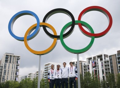 British tennis players Laura Robson, from left, Anne Keothavong, Andy Murray and Jamie Murray pose for photos with the Olympic rings at the Athletes' Village.