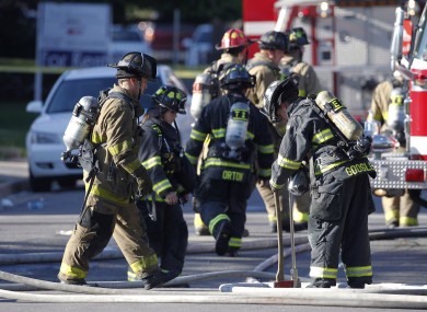 Firefighter work in front of James Holmes' apartment in Aurora.