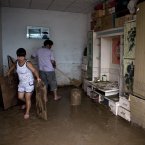 Villagers clean their flood-hit home at a village in Fangshan district of Beijing on Monday (AP Photo/Andy Wong)