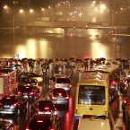 Rescuers search for missing people in a flooded street in Beijing at the weekend. (Photo by ChinaFotoPress)