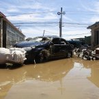 A damaged vehicle is seen after floodwaters receded (Photo by ChinaFotoPress)