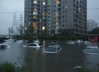 Vehicles submerged at a flooded residence community in Beijing at the weekend