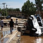Vehicles piled up in a ditch after floodwaters receded (Photo by ChinaFotoPress)