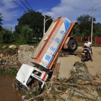 A damaged vehicle is seen after floodwaters receded (Photo by ChinaFotoPress)