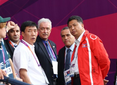 North Korean official Son Kwang Ho (second from the right) speaks to other officials during the delay.