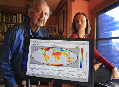 Richard Muller, left, and his daughter, Elizabeth Muller, right, pose with a map from their study on climate