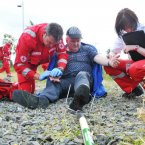 Cristiano Porchietto, and Italian Red Cross volunteer attends to an injured Liam Cullen during a simulated farm accident at FACE. 