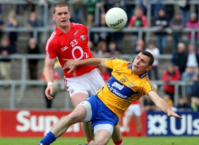 Cork's Fintan Goold challenged by Clare's Alan Clohessy in today's clash.