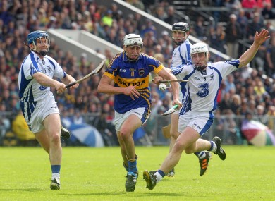 Tipperary's Patrick Maher tackled by Michael Walsh and Stephen Molumphy of Waterford.