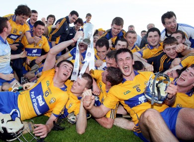 Clare players celebrate with the trophy after last night's game.