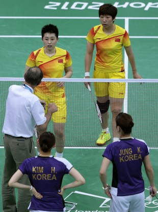 An official intervenes during the match between China and South Korea at Wembley Arena in London.