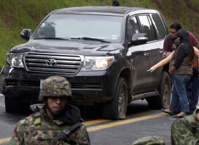 An armoured US embassy vehicle attacked by unknown assailants is checked by security personnel near Tres Marias, Mexico yesterday.