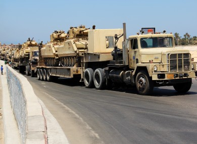 Army trucks carry Egyptian military tanks in El Arish, Egypt's northern Sinai Peninsula, Thursday, Aug. 9, 2012