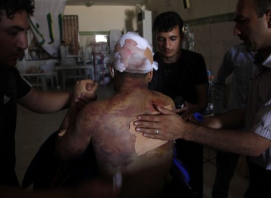 Mahmoud, a 21-year-old Palestinian resident of Syria, receives treatment in a field hospital after he was found Monday, Aug. 6, 2012,