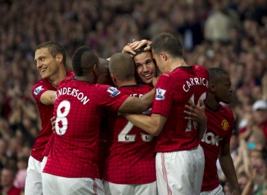 Van Persie is mobbed by his team-mates.
