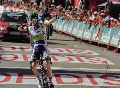 Simon Clarke celebrates in Bolt-esque fashion as he crosses the finish.