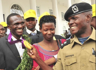 Kiprotich has his medal inspected by a Ugandan officer.